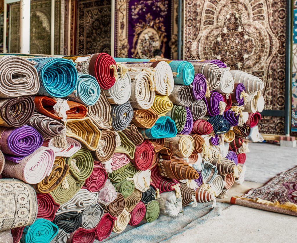 Heap of rolled up rugs in rug store