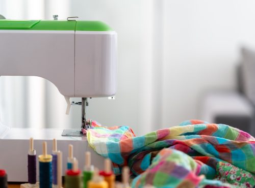 Sewing Machine with Colorful Fabric and Threads on Workstation